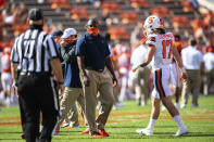 Syracuse head coach Dino Babers, center, and quarterback Rex Culpepper walk on the field before an NCAA College football game against Clemson in Clemson, S.C., on Saturday, Oct. 24, 2020. (Ken Ruinard/Pool Photo via AP)