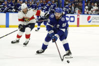 Tampa Bay Lightning left wing Brandon Hagel (38) gets off a shot after getting around Florida Panthers defenseman Ben Chiarot (8) during the second period in Game 4 of an NHL hockey second-round playoff series Monday, May 23, 2022, in Tampa, Fla. (AP Photo/Chris O'Meara)