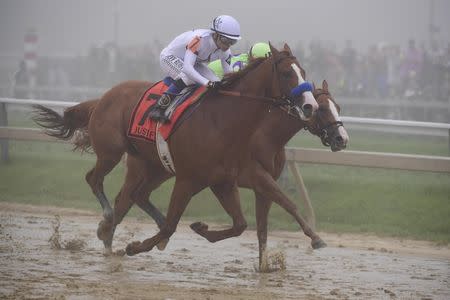 May 19, 2018; Baltimore, MD, USA; Mike Smith aboard Justify (7) passes Jose L. Ortiz aboard Good Magic (5) during the 143rd running of the Preakness Stakes at Pimlico Race Course. Mandatory Credit: Tommy Gilligan-USA TODAY Sports