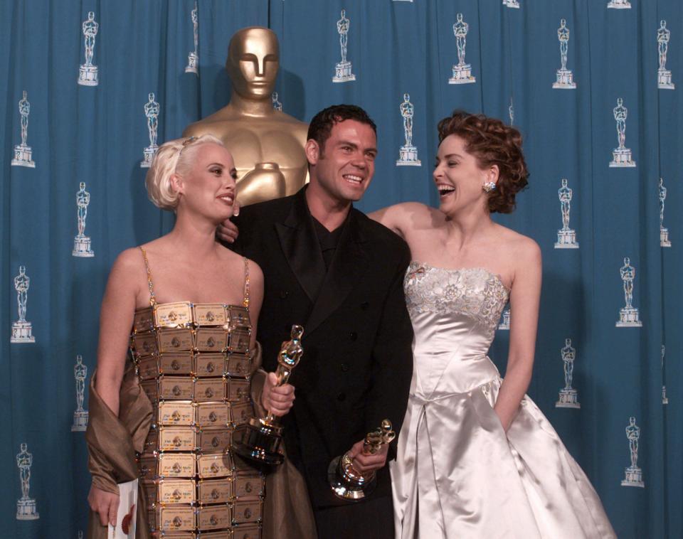 Lizzy Gardiner (left) and&nbsp;Tim Chappel, who won Best Costume Design in 1995, with presenter Sharon Stone. (Photo: ASSOCIATED PRESS)