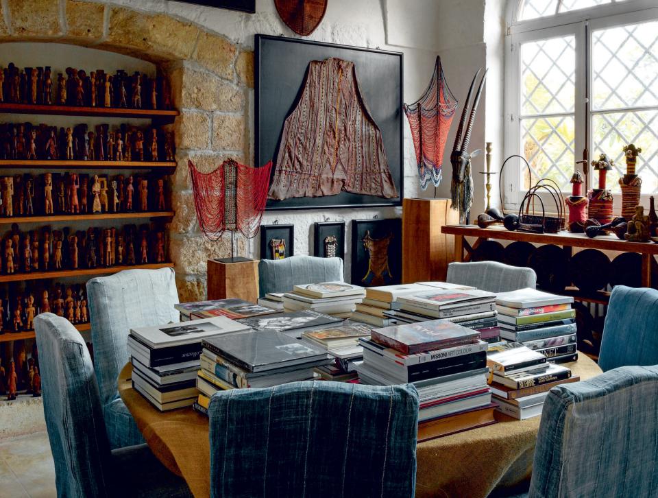 Surrounded by ancient textiles, the concrete home of Pedro Reyes and Carla Fernandez is stacked to the brim with books.