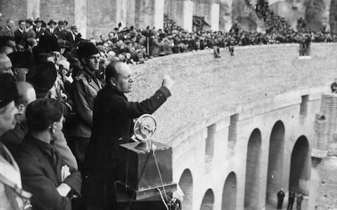 Benito Mussolini speaking at a rally in the Colosseum in Rome in 1920 - Credit: Hulton archive