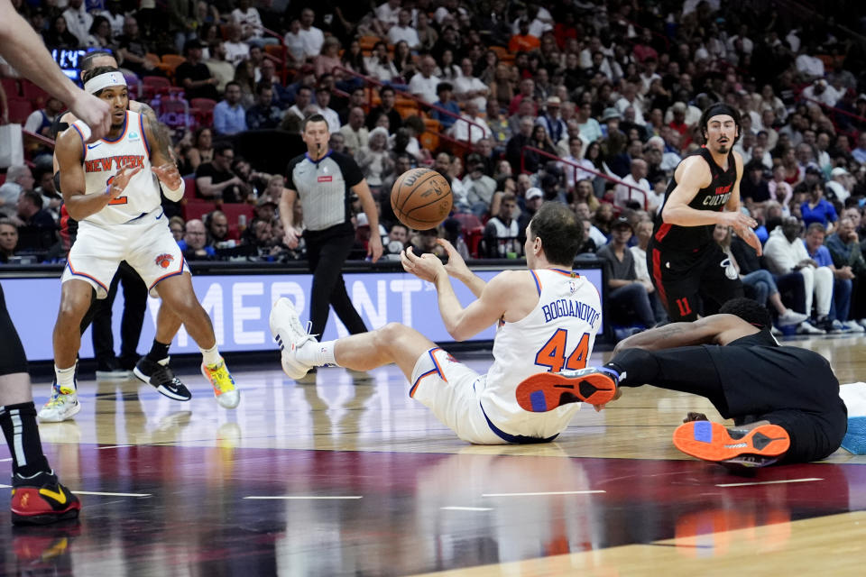 New York Knicks forward Bojan Bogdanovic (44) passes the ball to guard Miles McBride (2) during the first half of an NBA basketball game against the Miami Heat, Tuesday, April 2, 2024, in Miami. (AP Photo/Lynne Sladky)