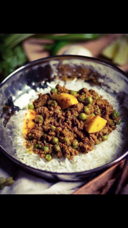 Ground beef, pea and potato curry served on fluffy basmati rice with a side of onion sambal