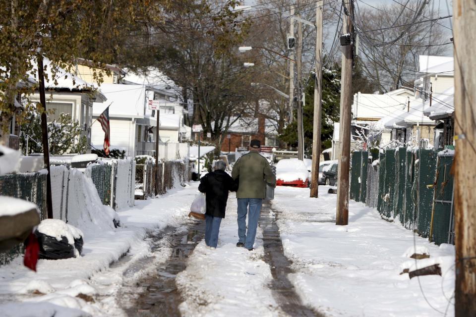 Snow masks much of the damage done to the New Dorp section of Staten Island, N.Y., Thursday, Nov. 8, 2012. The New York-New Jersey region woke up to a layer of wet snow and more power outages after a new storm pushed back efforts to recover from Superstorm Sandy. (AP Photo/Seth Wenig)