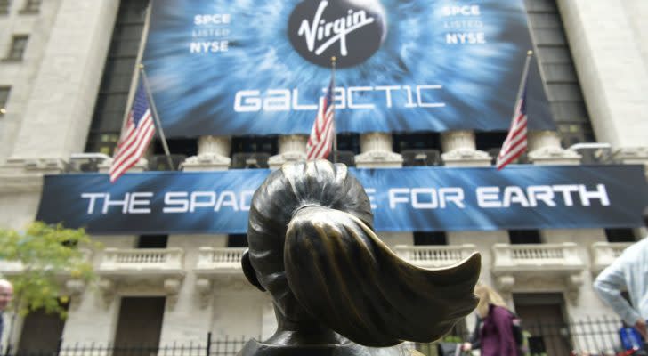 Virgin Galactic (SPCE) billboard on the New York Stock Exchange, across from the Fearless Girl statue. aerospace stocks