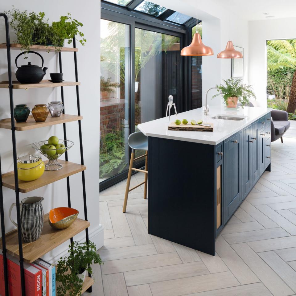 Kitchen island next to storage ladder in front of glass doors