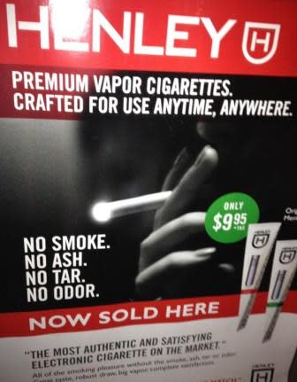 Ad outside a NY bodega for e-cigarettes, July 2013, Photo: Laura Newman. 