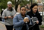<p>Jamie Weatherhead-Saul, center, of Woodridge, N.J., who was on the train that crashed into the Hoboken Terminal, walks away after speaking to reporters, Thursday, Sept. 29, 2016, in Hoboken, N.J. (AP Photo/Julio Cortez) </p>