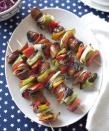 <p>Smoked sausages and a rainbow of grilled veggies make for the ultimate backyard barbecue fare. Bonus: You can prep and stack these kabobs ahead of time.</p><p><a href="https://www.goodhousekeeping.com/food-recipes/a10147/sausage-pepper-kabobs-recipe-ghk0710/" rel="nofollow noopener" target="_blank" data-ylk="slk:Get the recipe for Sausage-Pepper Kabobs »;elm:context_link;itc:0;sec:content-canvas" class="link "><em>Get the recipe for Sausage-Pepper Kabobs »</em></a></p>