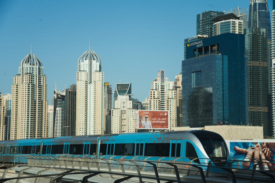FILE - In this April 26, 2020 file photo, the driverless Metro passes the Dubai Marina in Dubai, United Arab Emirate. For eager Israelis, anticipation is mounting that Dubai’s glitzy Burj Khalifa, will soon join the ranks of the Pyramids in Egypt and relics of the ancient Nabatean Kingdom of Petra in Jordan as an iconic landmark that was once unattainable but is now within reach. Last week’s dramatic announcement making the UAE just the third Arab nation to establish full diplomatic ties with Israel has set off a flurry of excitement. (AP Photo/Jon Gambrell, File)