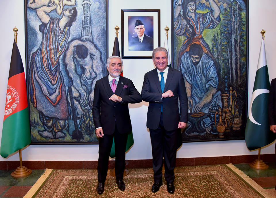 In this photo provided by Pakistan's Ministry of Foreign Affairs, Abdullah Abdullah, left, chairman of Afghanistan's High Council for National Reconciliation, bumps elbows with Pakistani Foreign Minister Shah Mahmood Qureshi, upon for a meeting, in Islamabad, Pakistan, Monday, Sept. 28, 2020. Afghanistan's top official in negotiations with the Taliban arrived in Pakistan's capital Monday on a three-day trip during which he will meet with the country's prime minister and other government officials. (Pakistan's Ministry of Foreign Affairs via AP)