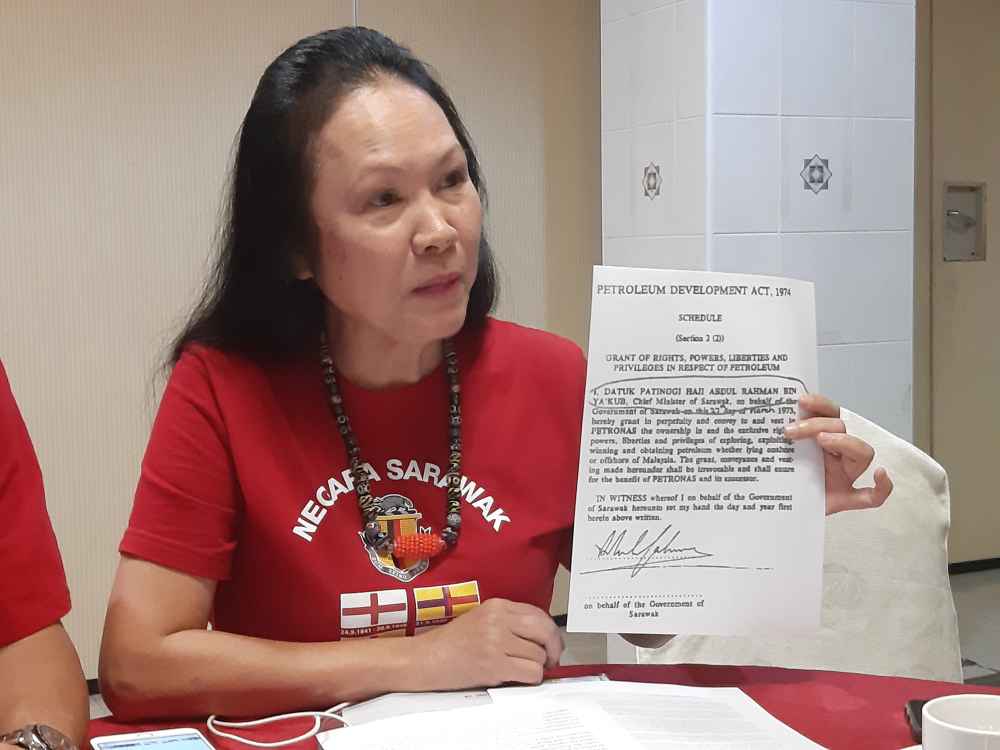 STAR president Lina Soo showing an agreement signed by former Chief Minister the late Tun Abdul Rahman Ya'kub granting in perpetuity the rights, powers, liberties and privileges in respect of petroleum , August 22, 2019. ― Picture by Sulok Tawie