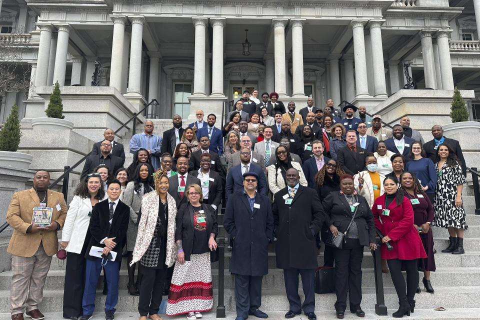 HOLD FOR DON KING - In this photo provided by Archana Sahgal, participants and funders of the Community Violence Intervention Collaborative gather for a photo at the Eisenhower Executive Office Building in Washington, D.C. on Dec. 8, 2022. (AP Photo/Archana Sahgal/Hyphen)