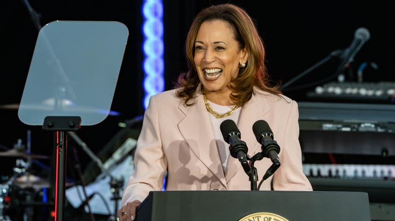 Kamala Harris smiling behind podium