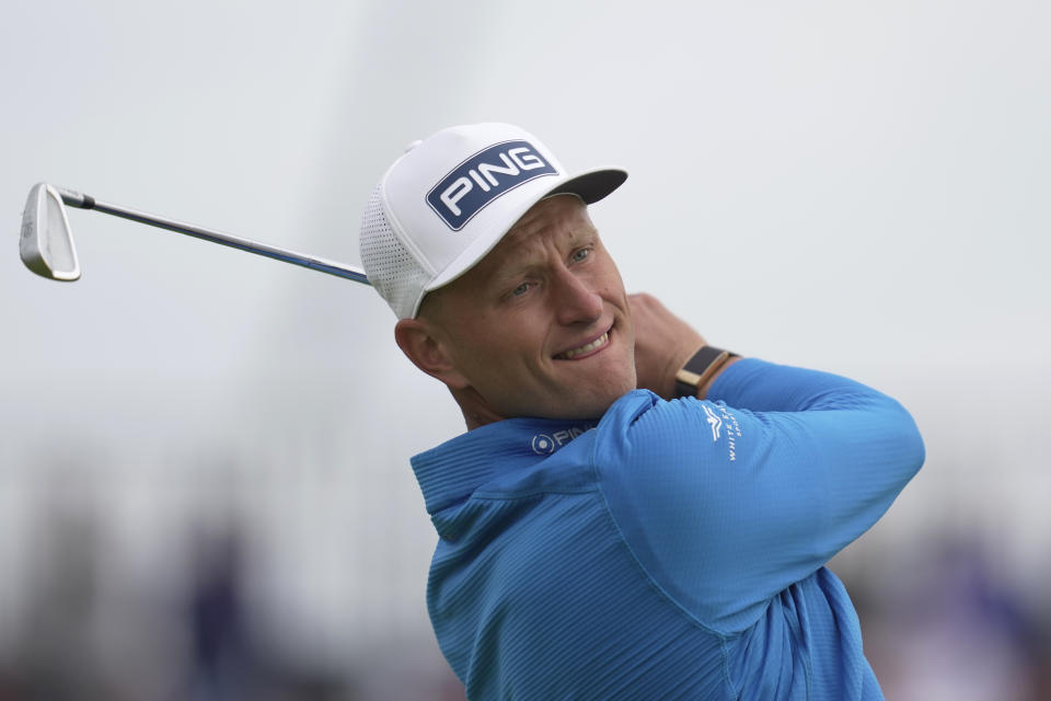 FILE - Poland's Adrian Meronk plays a shot from the 4th tee on the first day of the British Open Golf Championships at the Royal Liverpool Golf Club in Hoylake, England, Thursday, July 20, 2023. Meronk is one of the six players fighting for the third and final place up for grabs on the European Points List behind McIlroy and Rahm, as Robert MacIntyre is the driving seat. (AP Photo/Kin Cheung, File)