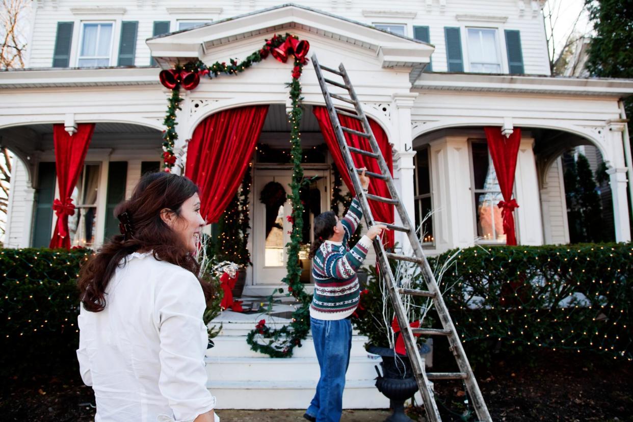 Middle aged couple decorating for the holidays