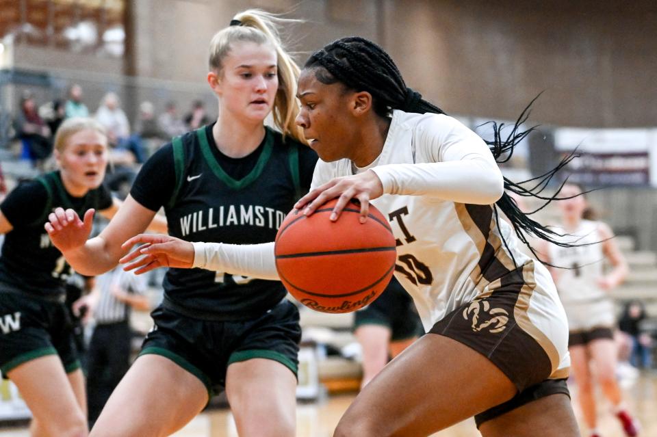 Holt's Rhema Dozier, right, moves the ball as Williamston's Claire Casey defends during the first quarter on Tuesday, Jan. 16, 2024, at Holt High School.