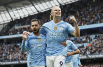 Manchester City's Erling Haaland, right, celebrates with Bernardo Silva after scoring his side's opening goal during the English Premier League soccer match between Manchester City and Wolverhampton Wanderers at the Etihad Stadium in Manchester, England, Saturday, May 4, 2024. (Richard Sellers/PA via AP)