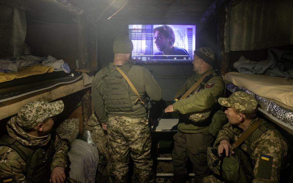 Members of the Ukrainian military watch TV in a bunker on the outskirts of Donetsk - Chris McGrath/Getty Images