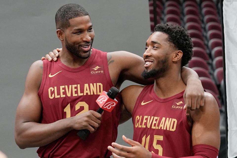 Cavaliers forward Tristan Thompson, left, interviews teammate Donovan Mitchell during media day, Monday, Oct. 2, 2023, in Cleveland.