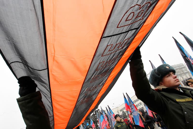 FILE PHOTO: Cadets of the separatist self-proclaimed Donetsk People's Republic military school hold a 300-meter St. George ribbon during the celebration of Saint George's Ribbon Day in Donetsk