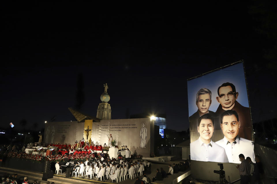 A poster depicting the Rev. Rutilio Grande, Franciscan priest Cosme Spessotto, Nelson Lemus and Manuel Solorzano, all victims of right-wing death squads during El Salvador’s civil war, is displayed during their beatification ceremony in San Salvador, Saturday, Jan. 22, 2022. (AP Photo/Salvador Melendez)