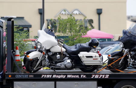 A motorcycle is seen on a wrecker before it is removed from the Twin Peaks restaurant, where nine members of a motorcycle gang were shot and killed, in Waco, May 19, 2015. REUTERS/Mike Stone