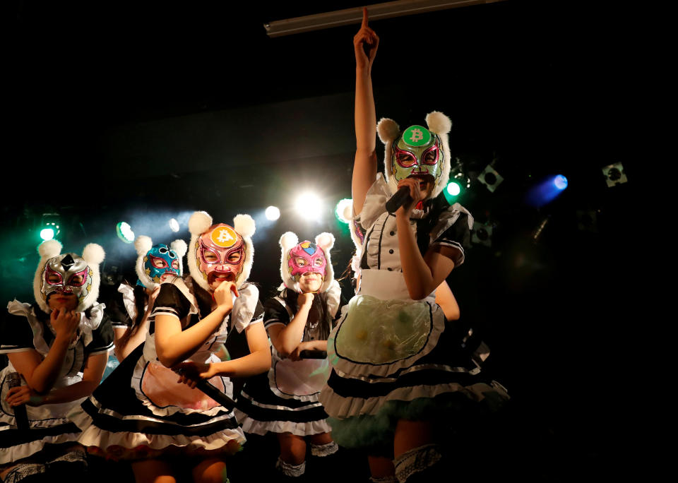 Members of Japan's idol group 'Virtual Currency Girls' wearing cryptocurrency-themed masks perform in their debut stage event in Tokyo, Japan. Photo: Kim Kyung-Hoon/Reuters