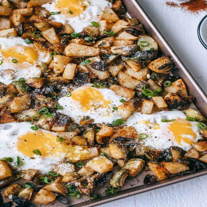 Sheet pan Brussels sprout and potato hash with eggs.