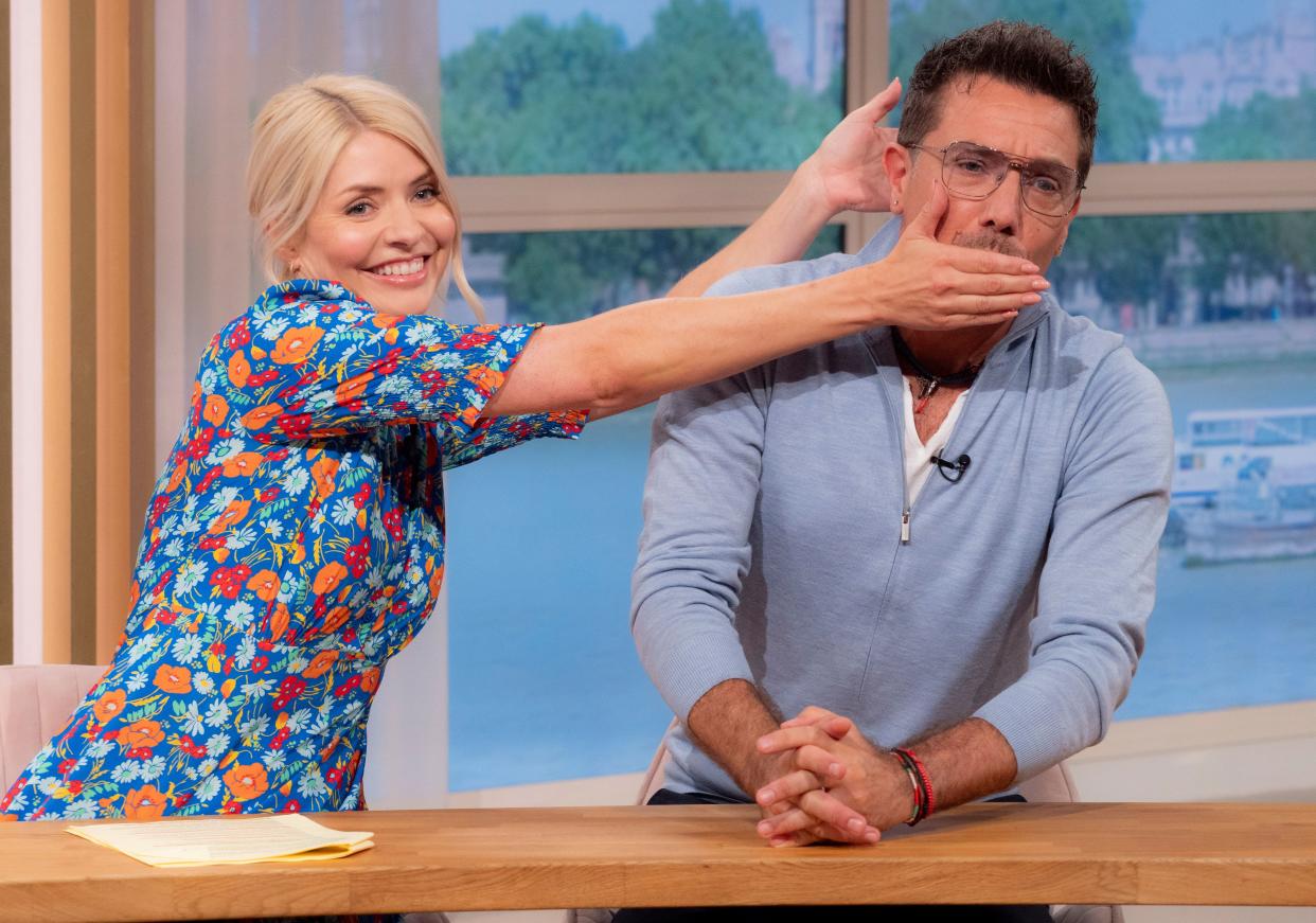 Holly Willoughby attempts to shush Gino D'Acampo on This Morning. (ITV/Shutterstock)