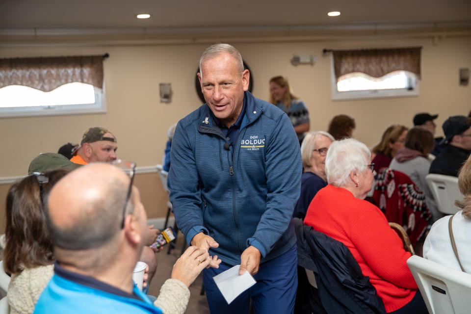 Republican Senate candidate Don Bolduc shakes hands with attendees during a campaign event on Oct. 15, 2022, in Derry, New Hampshire.  / Credit: Scott Eisen/Getty Images