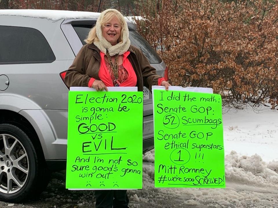 A woman stood outside Pete Buttigieg's town hall in Merrimack, New Hampshire, to give thanks to Sen. Mitt Romney for voting to convict President Donald Trump on one impeachment charge. (Photo: Amanda Terkel/HuffPost)