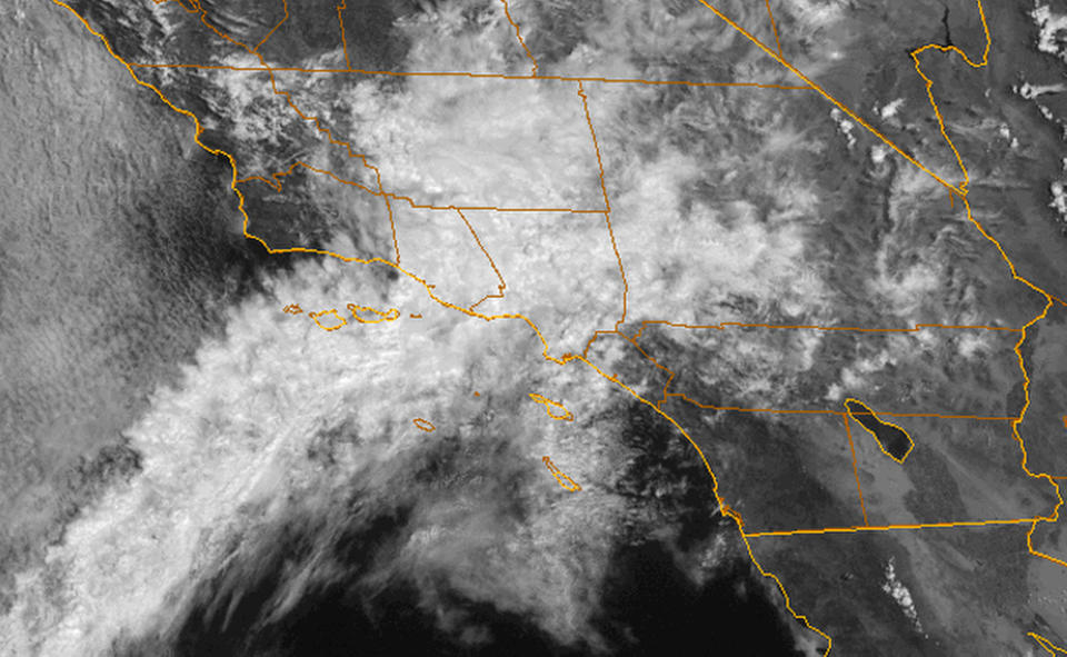 This satellite image provided by NOAA shows the California coastline with a plume of moisture from former Tropical Storm John bringing showers to Southern California on Wednesday, Sept. 5, 2012, including the area where a wildfire has been burning in the San Gabriel Mountains since the weekend. More than 1,200 firefighters were working to increase containment of the blaze northeast of Los Angeles. The National Weather Service said the chance of showers and thunderstorms would last through Thursday. (AP Photo/NOAA)