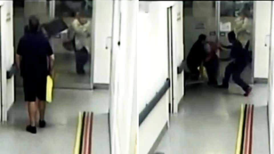 This is the shocking moment a patient pegs a chair at a glass door as a mother and baby walk past. Photo: 7 News