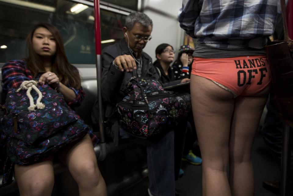 A woman takes part in the annual "No Pants Subway Ride" on a Mass Transit Railway (MTR) train in Hong Kong