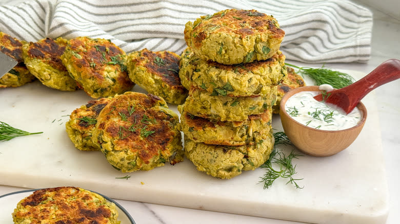 pea and dill patties stacked on board