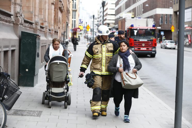 Emergency service workers help people in Stockholm (Rex)