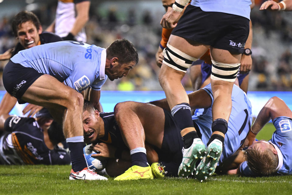 Harrison Goddard of the Brumbies, third left, scores a try agains the Waratahs during their Super Rugby Pacific Round 7 match in Canberra, Australia, Saturday, April 6, 2024. (Lukas Coch/AAP Image via AP)