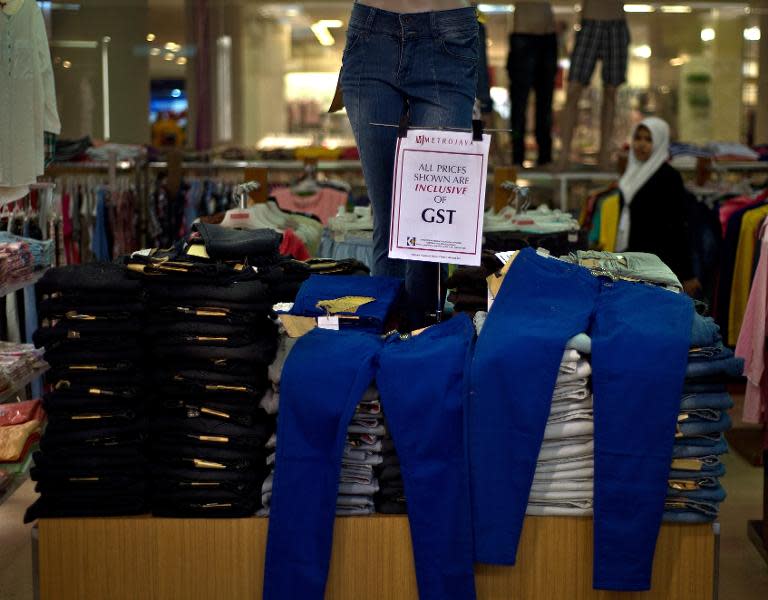 A signboard notifies customers of the six-percent goods and services tax (GST) on consumer goods at a mall in Kuala Lumpur, May 9, 2015