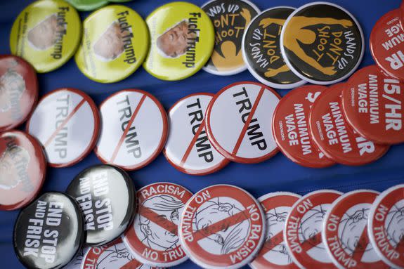 Anti-Trump buttons are for sale at a protest against Donald Trump's presidency in 2016.