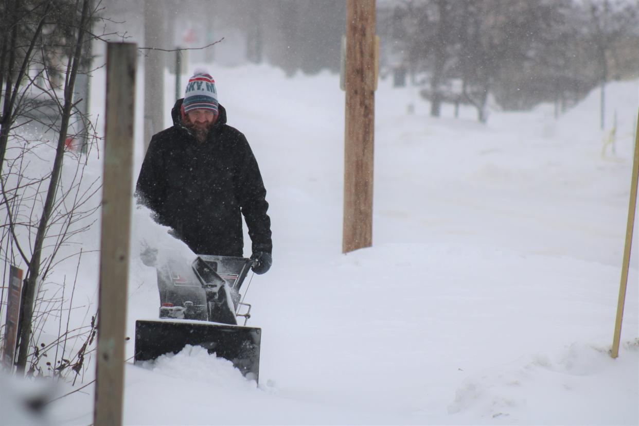 A Cheboygan resident works with his snow blower on Saturday, Jan. 13, 2024 during a winter storm.