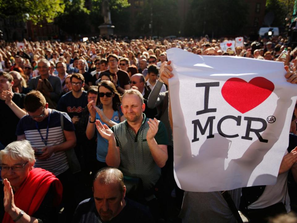 Crowds gather for a vigil in Albert Square (AP)