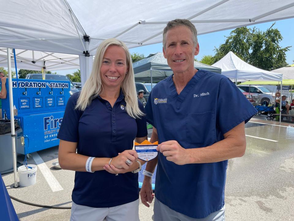 Katie Levan and Dr. Mitch Rosenzweig of Embassy Veterinary Centers are on hand to provide medical care at Dog Daze VI held at Village Green Shopping Center in Farragut Saturday, Aug. 13, 2022.