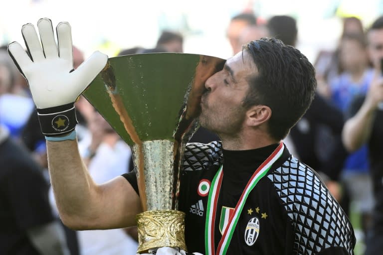 Juventus' goalkeeper from Italy Gianluigi Buffon kisses the trophy after winning the Italian Serie A football match Juventus vs Crotone and the "Scudetto" at the Juventus Stadium in Turin on May 21, 2017