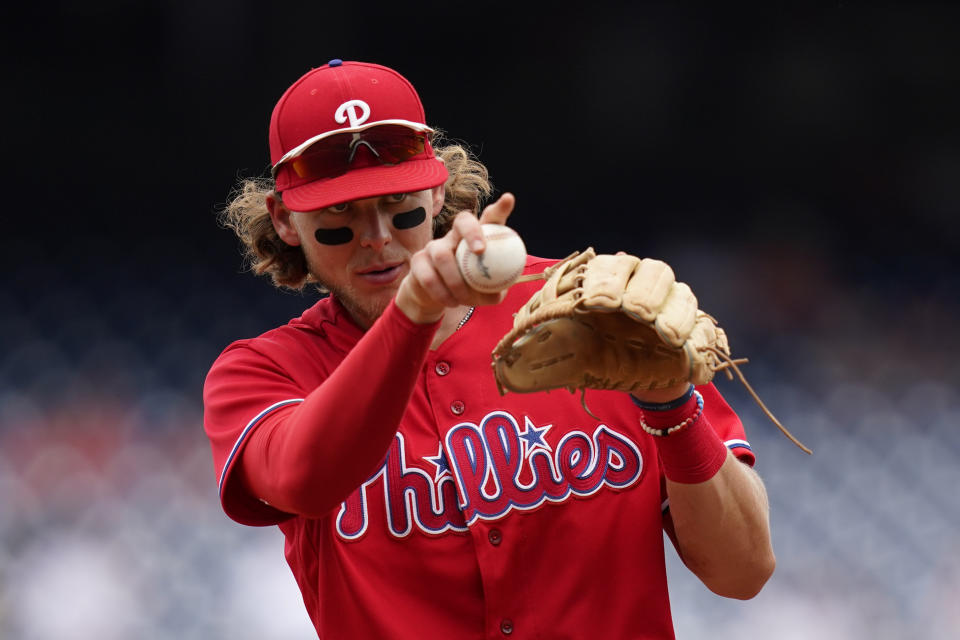 Philadelphia Phillies third baseman Alec Bohm warms up between innings of the first game of a baseball doubleheader against the Washington Nationals, Friday, June 17, 2022, in Washington. (AP Photo/Patrick Semansky)