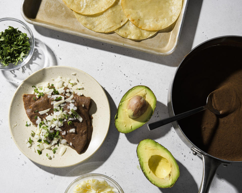 This image released by Milk Street shows a recipe for black bean enfrijoladas. (Milk Street via AP)