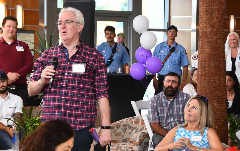 Mark Stapleton, standing by his wife, Eileen, tells the crowd about the extensive injuries he suffered in a serious car wreck during the National Trauma Survivors Day reunion at Holmes Regional Medical Center in Melbourne.