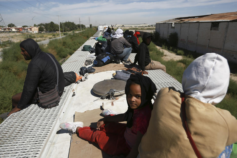 Migrants travel on a freight train, arriving in Ciudad Juarez, Mexico, Thursday, Sept. 28, 2023. (AP Photo/Christian Chavez)