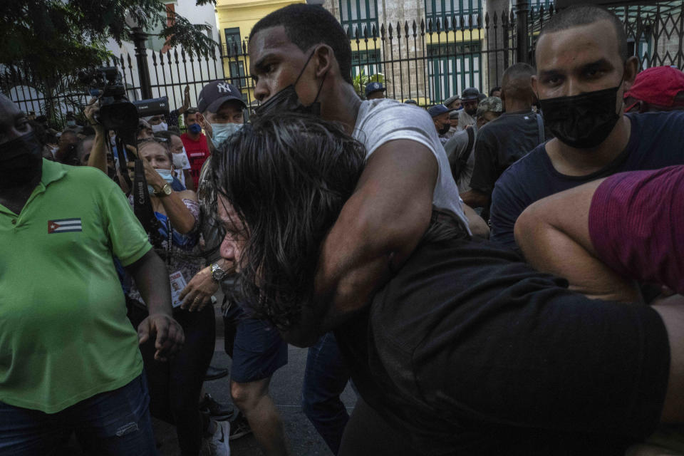 Plainclothes police detain an anti-government protester during a protest in Havana, Cuba, Sunday, July 11, 2021. Hundreds of demonstrators went out to the streets in several cities in Cuba to protest against ongoing food shortages and high prices of foodstuffs, amid the new coronavirus crisis. (AP Photo/Ramon Espinosa)